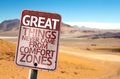 Great Things Never Came From Comfort Zones sign with a desert background