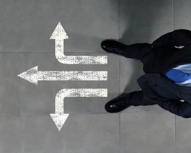 Top view of businessman standing against directions background